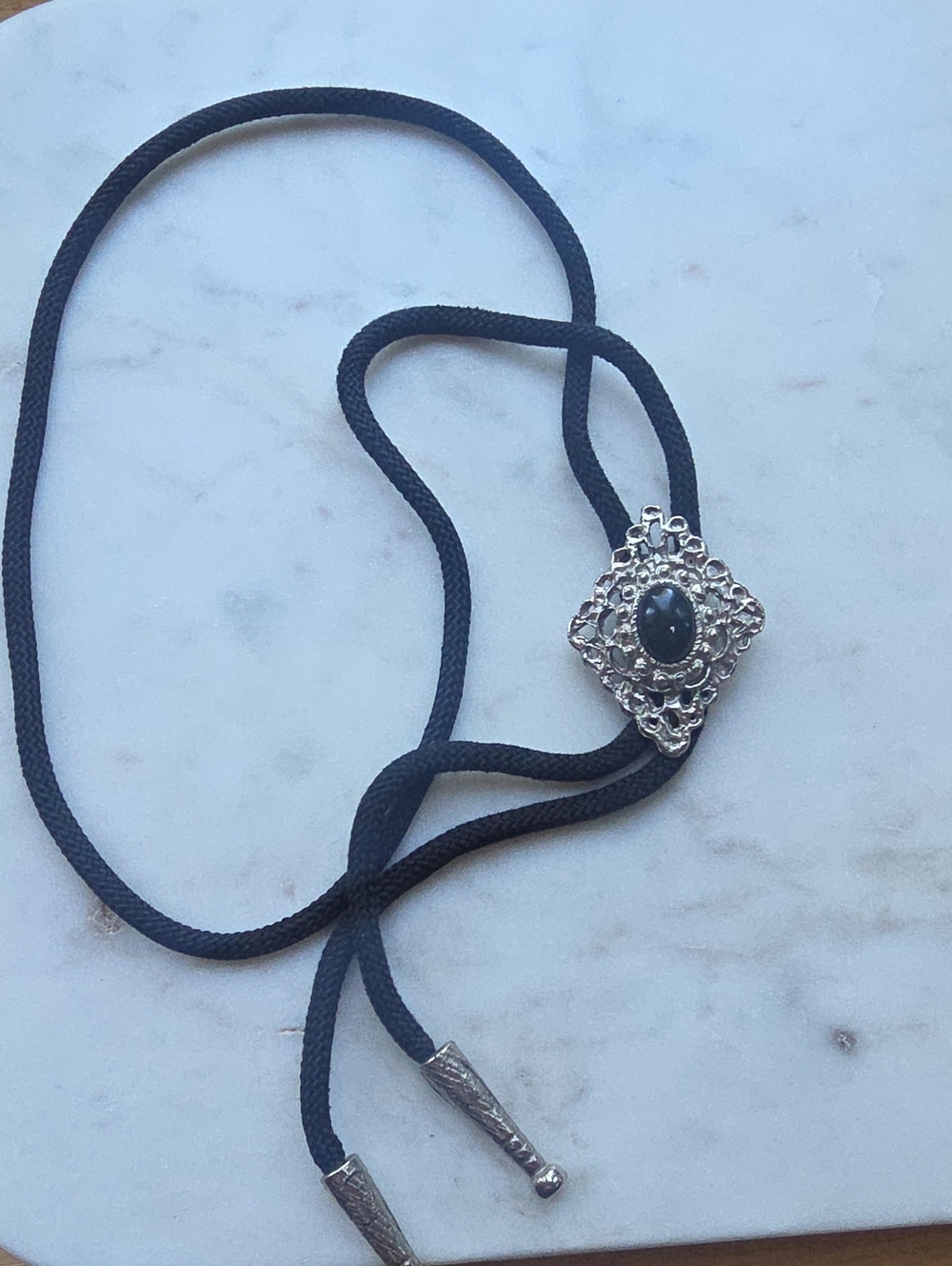 vintage silver-tone western bolo tie featuring an openwork filigree frame
